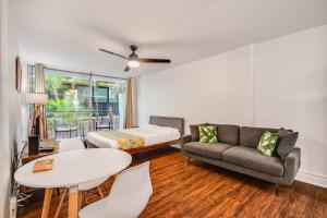 a living room with a couch and a bed and a table at 2413 Kuhio in Honolulu
