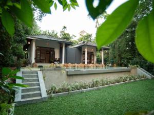 a house with a swimming pool in a yard at The Lush - Luxury Villa in Unawatuna