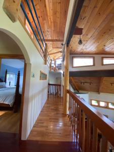 a room with a bed and a wooden staircase at The Pine Lodge in Northport +35 photos