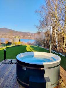 a jacuzzi tub on a deck next to a golf course at LakeHouse nad Jeziorem Żywieckim in Żywiec