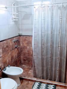 a bathroom with a shower with a toilet and a sink at Casa Emilia Tanti in Tanti