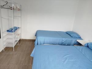a bedroom with two beds and a basketball hoop at CASA DE PLAYA FRENTE AL MAR k173 in San Vicente de Cañete