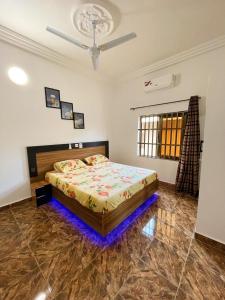 a bedroom with a bed and a ceiling fan at Housing by imelda in Godomey