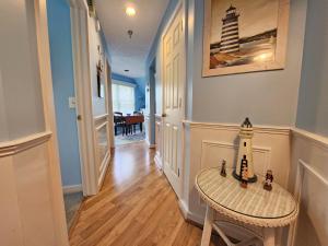 a hallway with a table with a lighthouse on it at North Shore Inn TC 301 in Traverse City