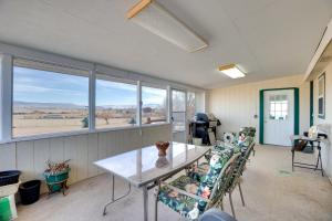 a room with a table and chairs and windows at Hot Tub and Screened Porch Getaway in Montrose! in Montrose