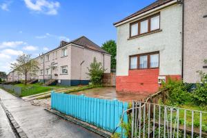 a flooded street with houses and a blue fence at 3 Bedrooms Homely House in Motherwell Sleeps 8 comfortably with 6 double beds Near Glasgow Edinburgh Free Private Parking Business Travellers Contractors Holiday Goers Near all Major transport links in Carfin
