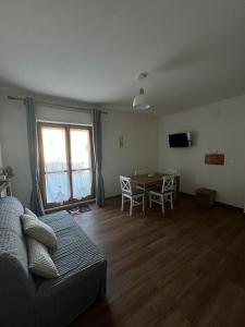 a living room with a couch and a table at Attico - Terrazza su Castello in Castel di Sangro