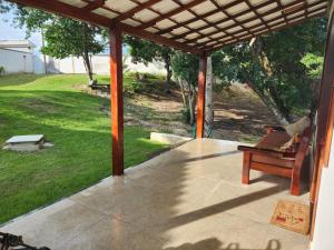 a screened in porch with a piano on it at Suíte Praia Seca com ar condicionado in Araruama