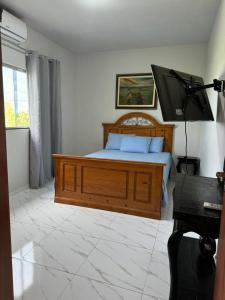 Katil atau katil-katil dalam bilik di Casa Temporada Aconchego e tranquilidade 3