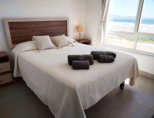 Postel nebo postele na pokoji v ubytování Smart Host Rentals - Vive un Paraíso Frente al Mar + 12 fotografií