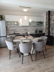 a dining room with a table and chairs and a kitchen at Apartments Grdelin in Trogir +11 photos