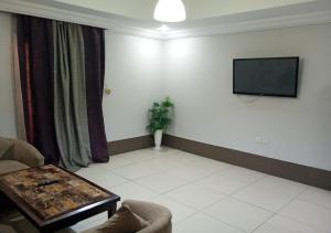 TV o dispositivi per l'intrattenimento presso فندق أصالة الحمراء
