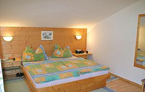 una camera da letto con un letto grande con cuscini verdi di Edthof a Lungötz
