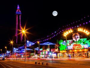 a city lit up at night with a tower at Q Accommodation in Blackpool