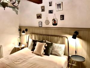 a bedroom with a bed and pictures on the wall at Casa di pietra in Castelnuovo di Val di Cecina