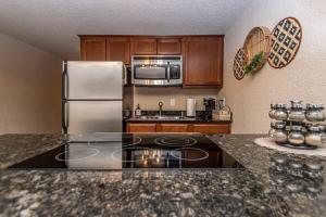 a kitchen with a refrigerator and a counter top at Dock Holiday! in Hot Springs +23 photos