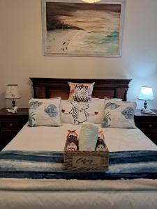 a bedroom with a bed with two baskets on it at Seaside Paradise in Kingsburgh +52 photos