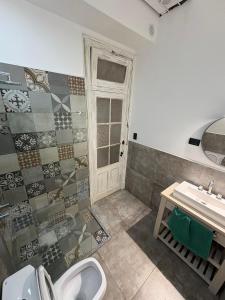 a bathroom with a toilet and a sink at Don Tino in San Pedro +6 photos
