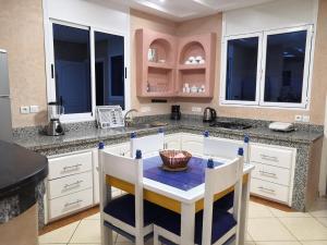 a kitchen with a island with a table and chairs at Stone house in Mirleft