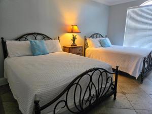 a bedroom with two beds and a lamp at Beach Colony 18A in Pensacola +25 photos