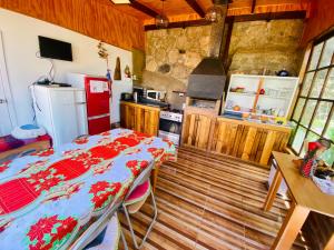 a kitchen with a table and a stove and a refrigerator at La Palma in Viña del Mar
