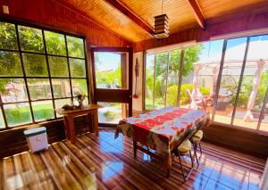 a dining room with a table in a room with windows at La Palma in Viña del Mar