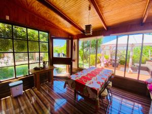 a room with a table in a room with windows at La Palma in Viña del Mar