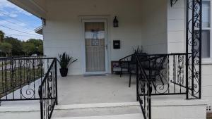 a porch of a house with a gate and a door at Cute 2B2B House, walk to Sponge Dock, Pet friendly in Tarpon Springs +12 photos