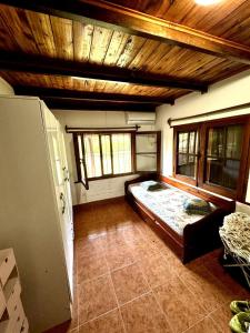 a bedroom with a large bed in a room with windows at La casa quinta de Camino in Gualeguaychú
