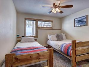 a bedroom with two beds and a ceiling fan at Luxury By The Lake in Dillon +41 photos
