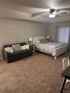 a living room with a bed and a couch at Schertz Country Farmhouse on 1 acre with Gameroom in Schertz