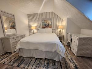 a bedroom with a white bed and two night stands at North Shore Inn TC 400 in Traverse City +12 photos