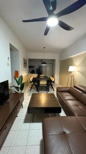 a living room with a couch and a ceiling fan at Vista Home in Kajang