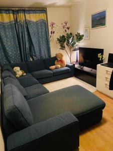 two teddy bears sitting on a couch in a living room at 2 bedroom apartment in Lijordet
