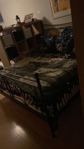 a bedroom with a bed with a blanket on it at Room in 2 bedroom apartment in Lijordet