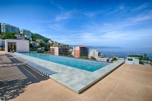 a swimming pool on the roof of a building at HGTV Loft | Rooftop Pool + Gym + Views + Bar in Puerto Vallarta