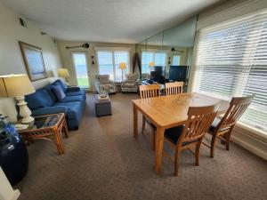 a living room with a table and a blue couch at North Shore Inn TC 106 in Traverse City