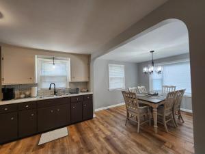 a kitchen and dining room with a table and chairs at Cozy & Roomy 3BR 8-9 mins to Buffalo Bills in Lackawanna