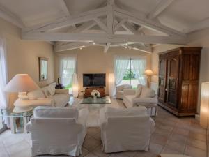 a living room with white furniture and a fireplace at La Sarrazine in Les Mées