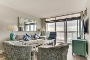 a living room with a couch and chairs and a television at Oceanfront North Myrtle Beach Gem Pools Access! in Myrtle Beach