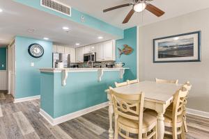 a kitchen and dining room with a table and chairs at Oceanfront North Myrtle Beach Gem Pools Access! in Myrtle Beach