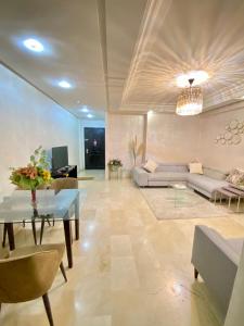a living room with a couch and a table at Appartement de lux in Casablanca