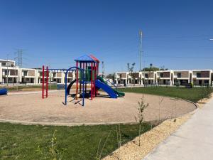 a playground with a slide in a park at Casa Milos 7 Min from the Consulate in Manuel F. Martínez