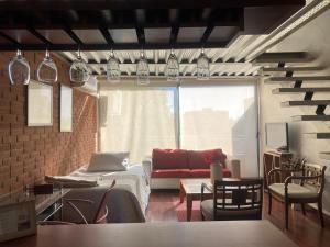a living room with a bed and a couch at Depto Manuel Montt Providencia in Santiago