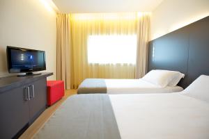 Posteľ alebo postele v izbe v ubytovaní Mercure Nerocubo Rovereto