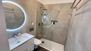 a bathroom with a sink and a shower with a mirror at Coastal Nest in Alcalá in Alcalá +59 photos
