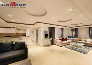 a large living room with couches and a kitchen at Pretty 4Bedrooms Penthouse MB7 at New Abu Tig Marina in Hurghada