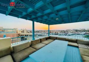 a rooftop balcony with a view of the city at Pretty 4Bedrooms Penthouse MB7 at New Abu Tig Marina in Hurghada