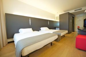 Posteľ alebo postele v izbe v ubytovaní Mercure Nerocubo Rovereto