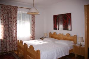 ein Schlafzimmer mit einem großen Bett mit weißer Bettwäsche in der Unterkunft Gasthof Gerlinde Gibiser in Heiligenkreuz im Lafnitztal